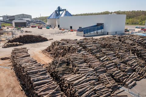 Logs stacked outside UPM's plant, ready to be processed into feedstocks for polymers